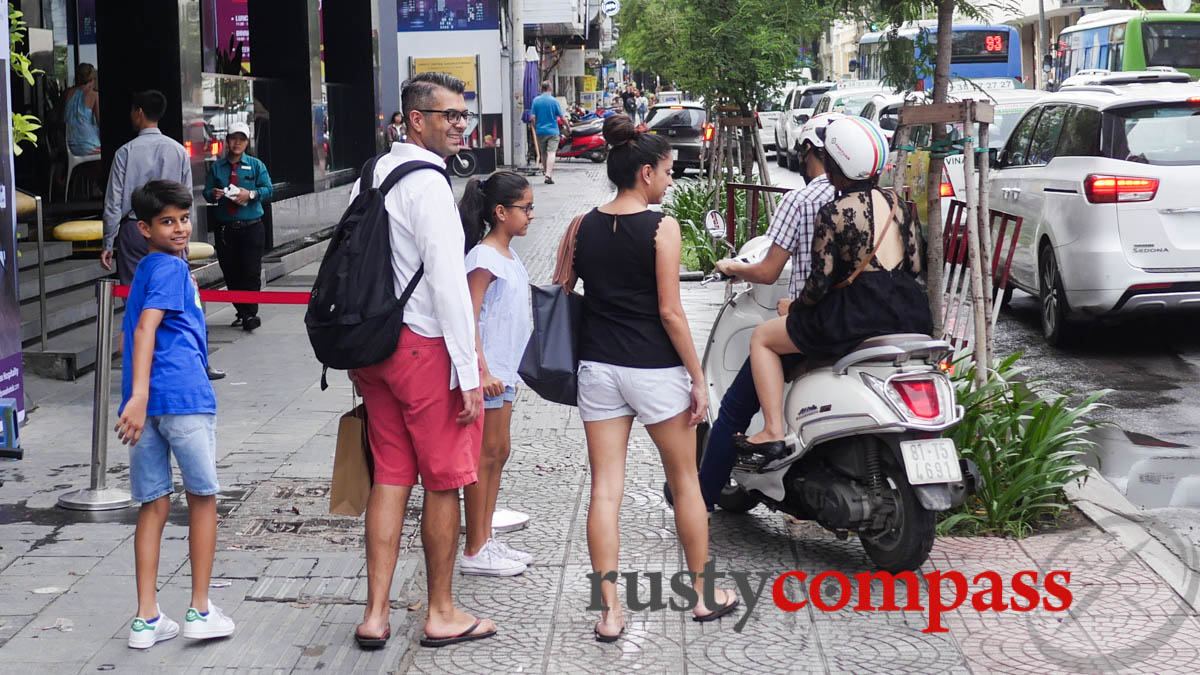 Tourists learning some of Saigon's unusual traffic practices.